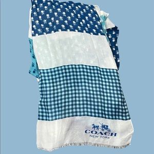large coach scarf with various blue patterns (floral, flannel).